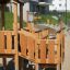 Rubik Modern Nature wooden playhouse with slide in un parco di quartiere.