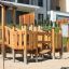 Rubik Modern Nature wooden playhouse with slide in un contesto di area giochi.