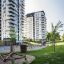 Attrezzature moderne per parchi giochi Atakama in una zona residenziale con alti edifici sullo sfondo.