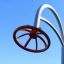 Una moderna struttura da arrampicata per parco giochi chiamata Blossom con un design circolare arancione su sfondo blu 