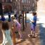 Bambini che giocano su attrezzatura da palestra all'aperto Somersault Triple nel cortile della scuola.