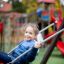 Bambino su Safety Seat Single Swing nel parco giochi.